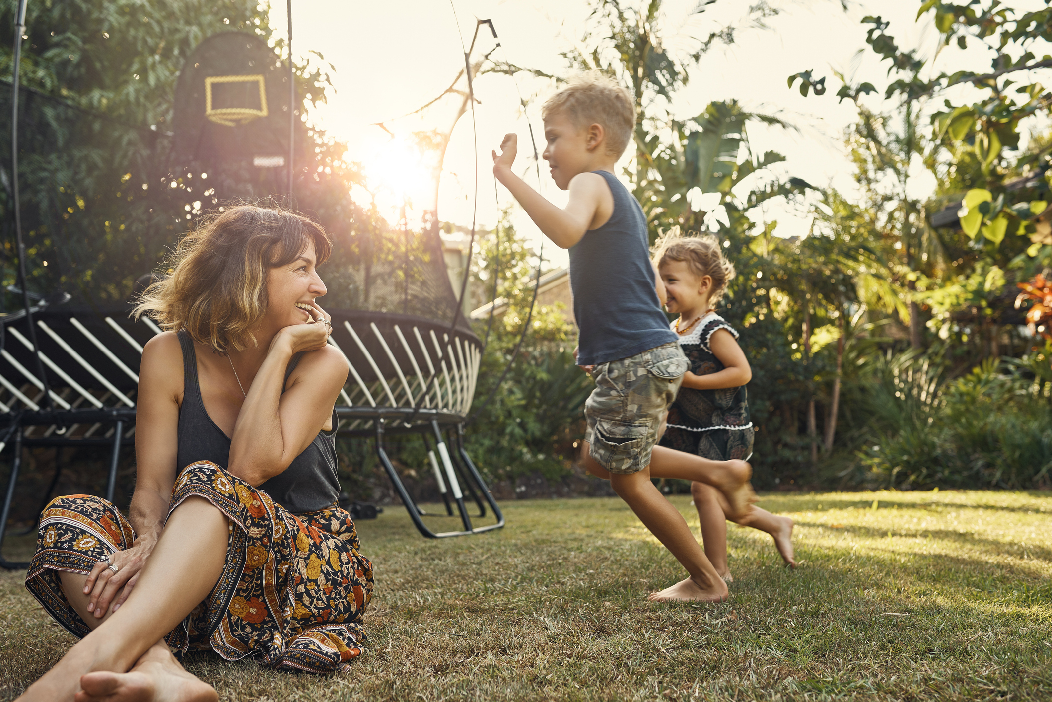Family playing together in the garden at sunset